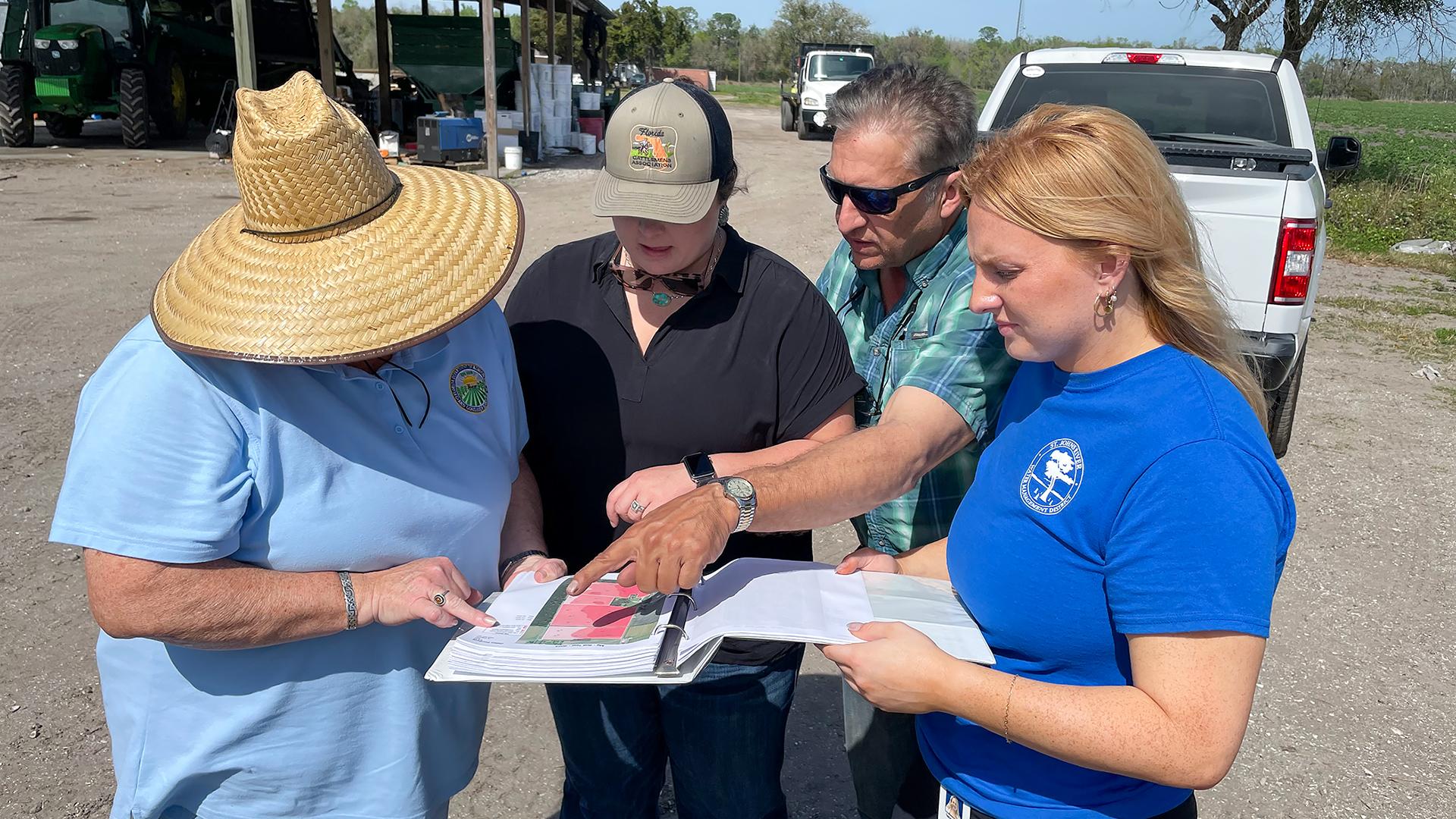 People having a meeting out in a farm